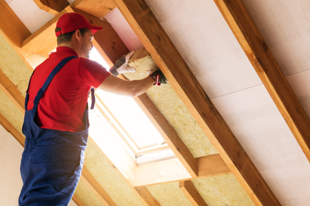 Man installing insulation