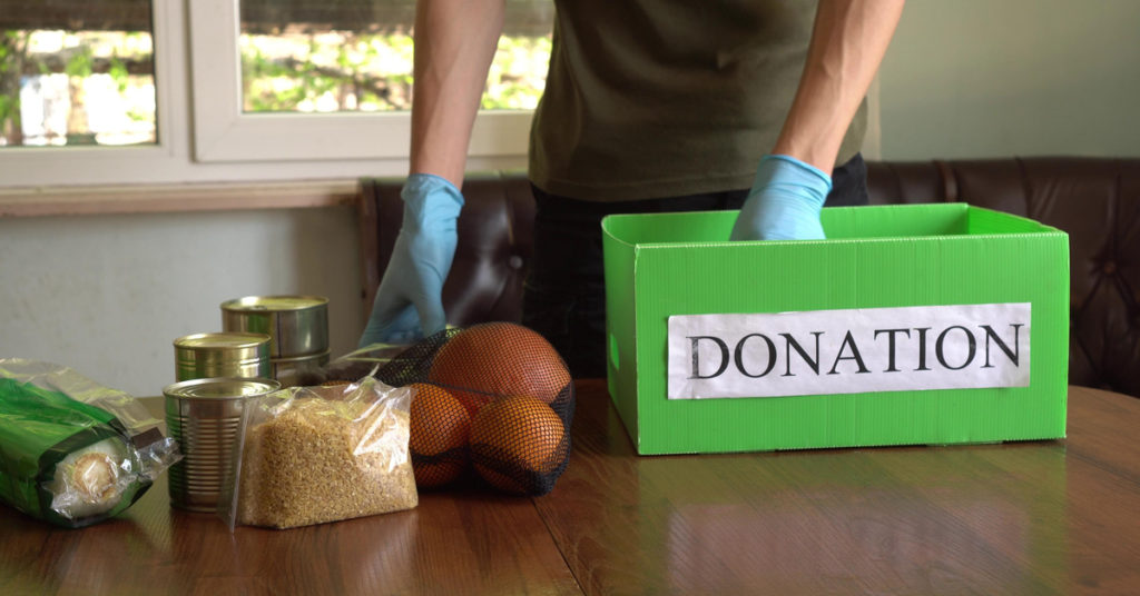 Man Filling Donation Box