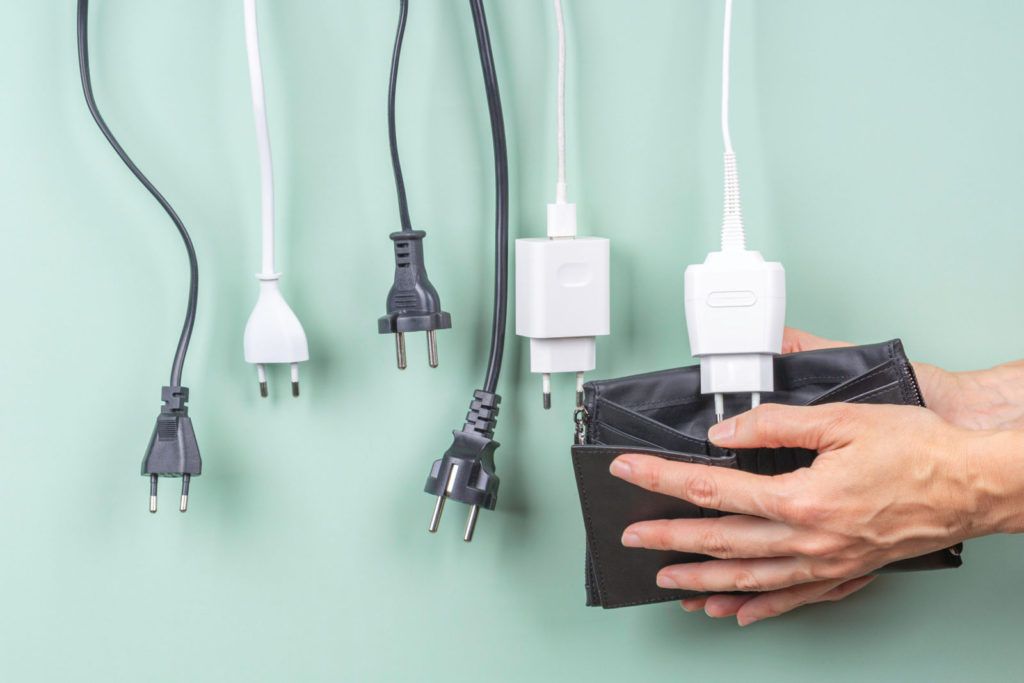 Power cords hanging over a wallet as National Grid electricity prices in Massachusetts set to increase