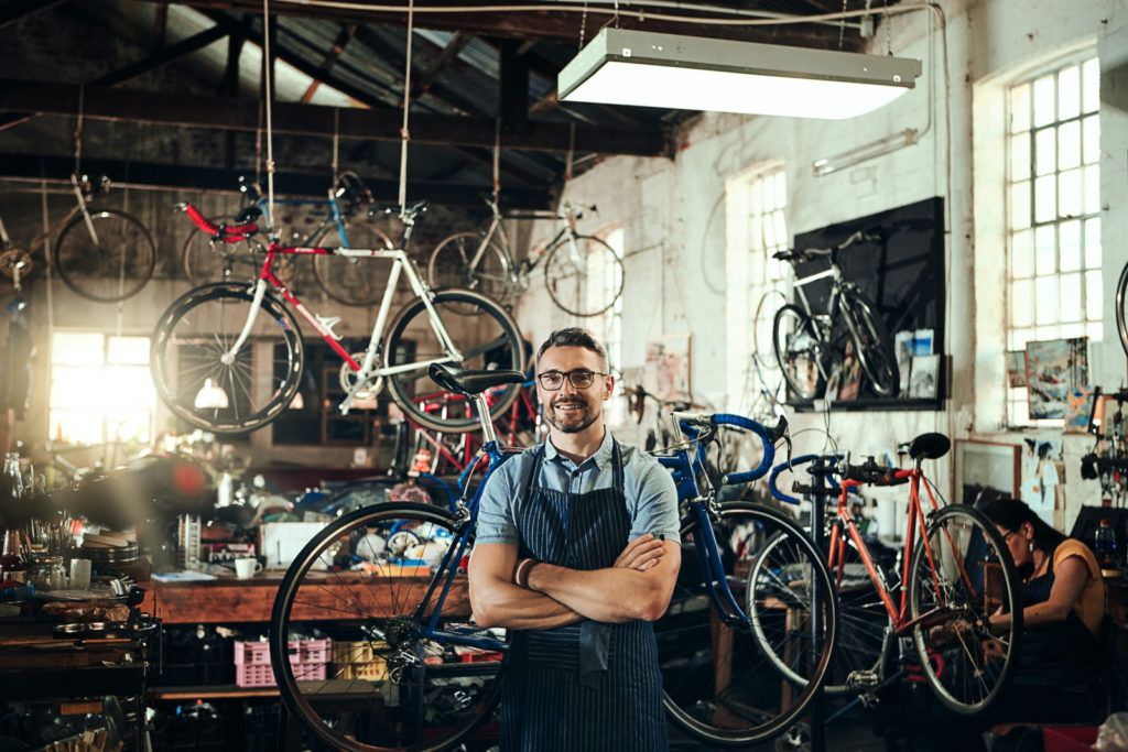 What is making my small business electricity bill so high? Photo of a small business owner in his bike shop.
